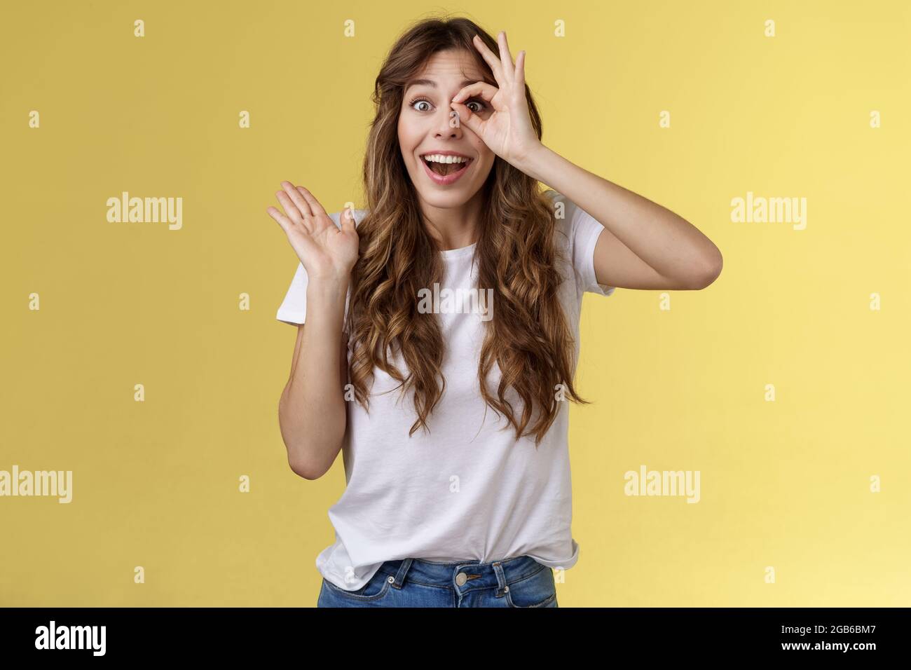 Oh hi I see you. Fascinated cute charming young girl waving palm say