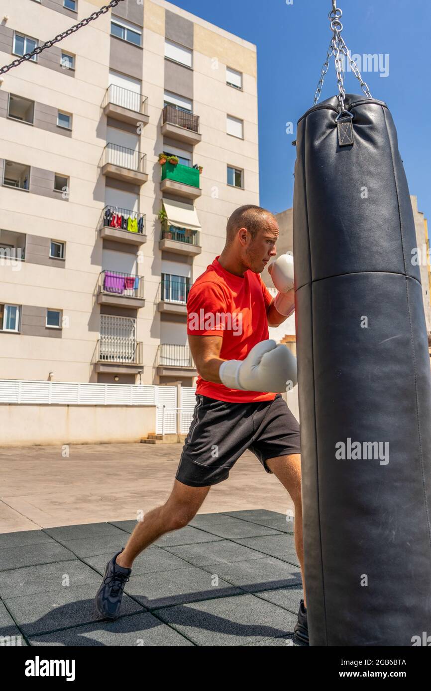 Street Fighter in Black Clothes and Bandages on the Wrist Boxing in