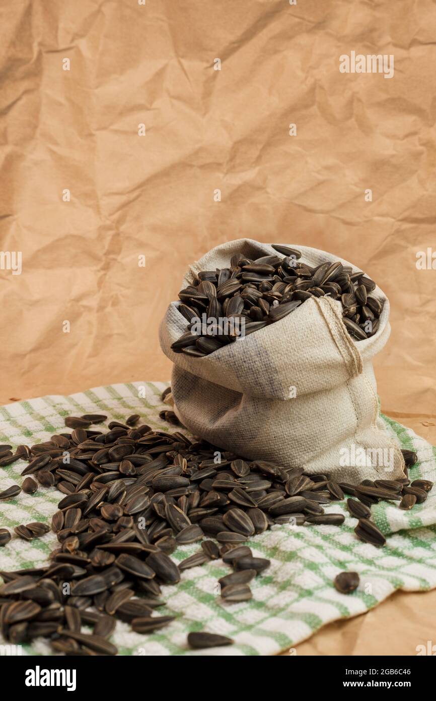 pouch with sunflower seeds on paper background Stock Photo