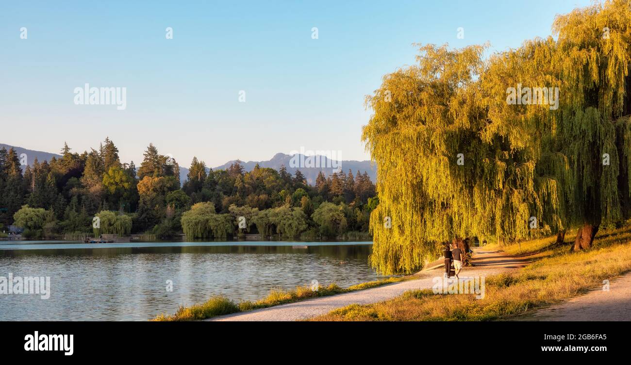 Lost Lagoon in Stanley Park during sunny summer sunset. Stock Photo