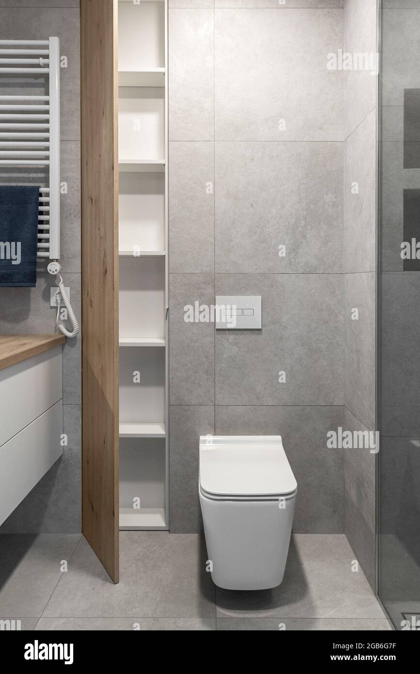 Modern minimalist bathroom interior design with grey stone tiles and wood wall  texture Stock Photo - Alamy, image size:866x1390