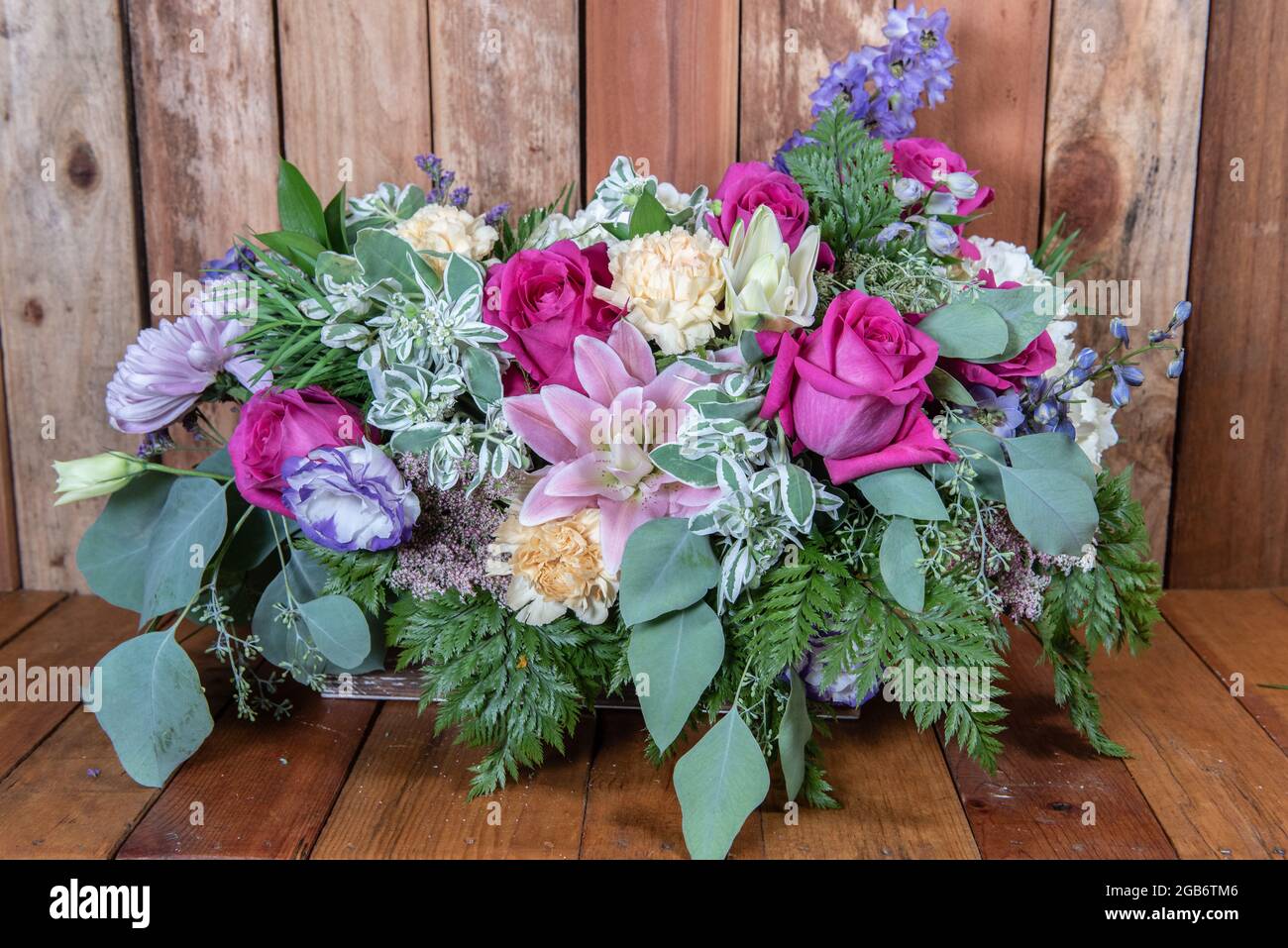 Beautiful bouquet of arranged roses, stargazers, chrysanthemums, and daisys in a long and full display of beauty. Stock Photo