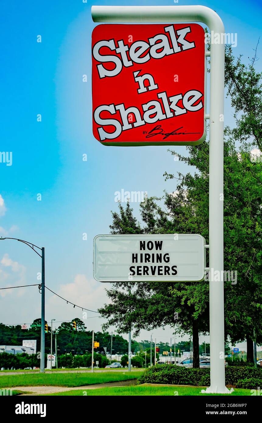 Steak ’n Shake restaurant displays a “now hiring sign” on Highway 90, Aug. 1, 2021, in Mobile, Alabama. Steak ’n Shake was founded in 1934 in Illinois. Stock Photo