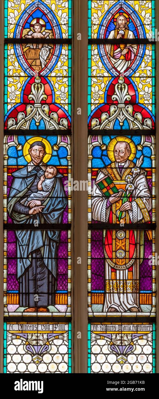 VIENNA, AUSTIRA - JUNI 24, 2021: The St. Vincent de Paul and Clement Maria Hofbauer on the stained glass of church St. Severin. Stock Photo