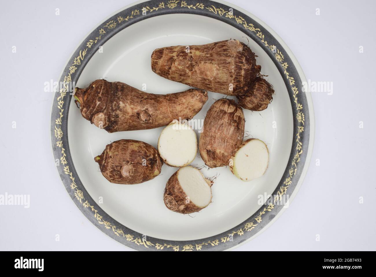 Taro root on white background. Colocasia elephant ear plant root rhizome vegetable also known as Arbi or Arvi Stock Photo