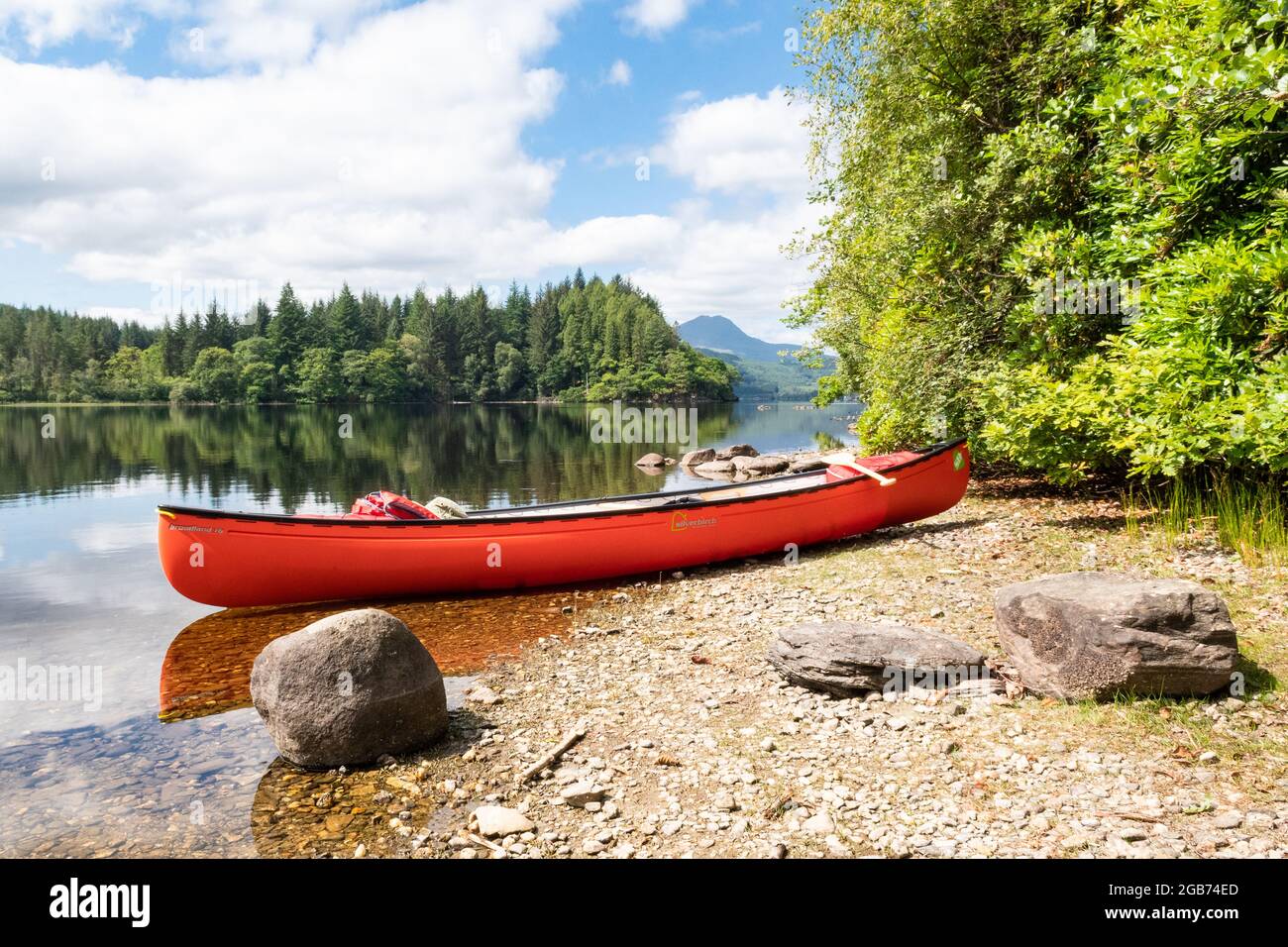 Canoeing on Loch Ard with Ben Lomond in the distance, Loch Lomond and the Trossachs National Park, Aberfoyle, Stirling, Scotland, UK Stock Photo