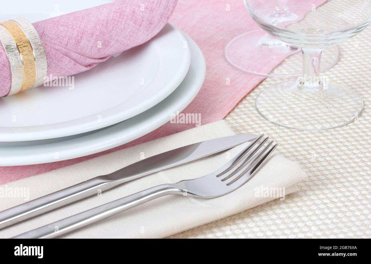Table setting with fork, knife, plates, and napkin Stock Photo - Alamy