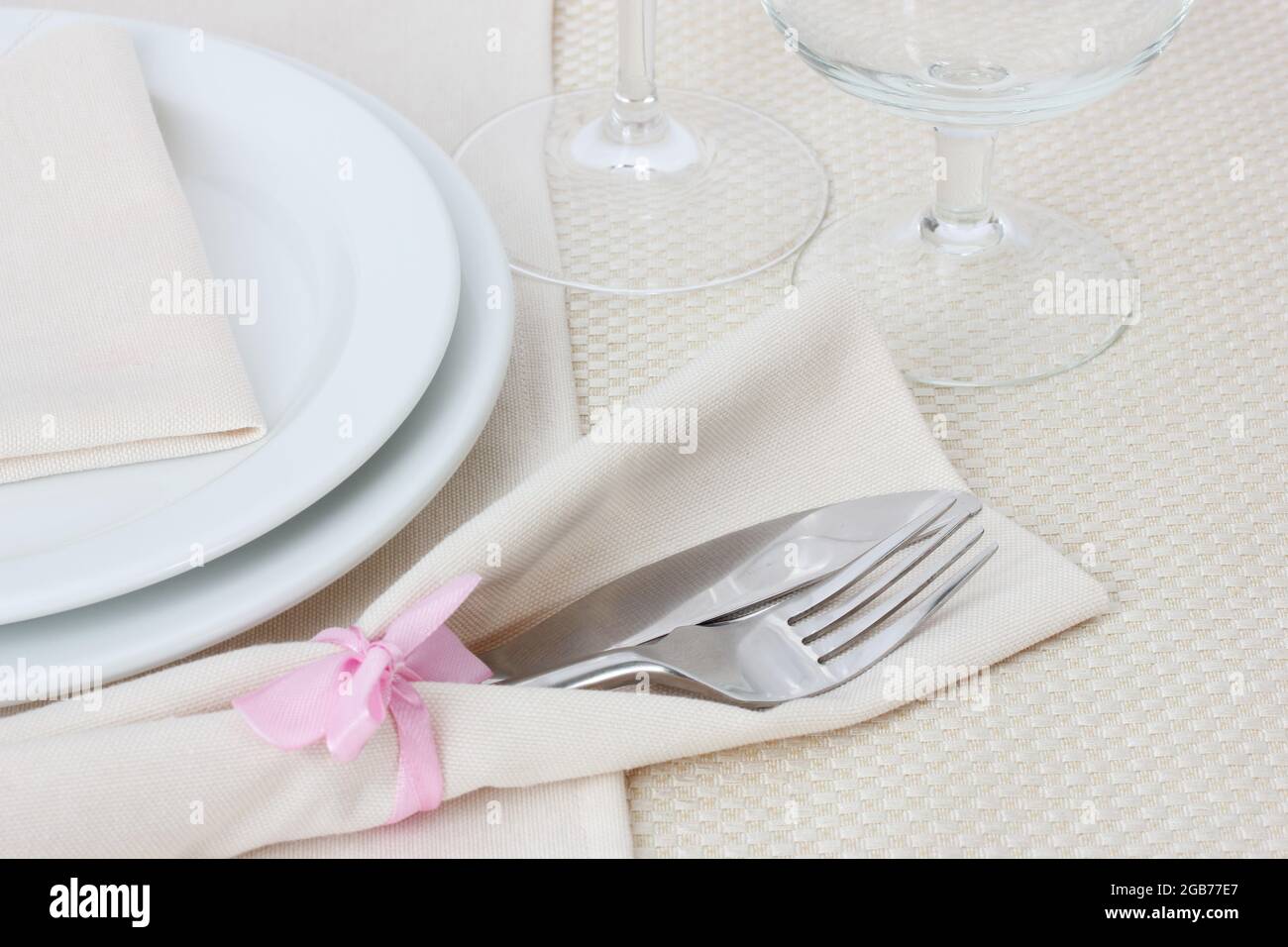 Table setting with fork, knife, plates, and napkin Stock Photo - Alamy