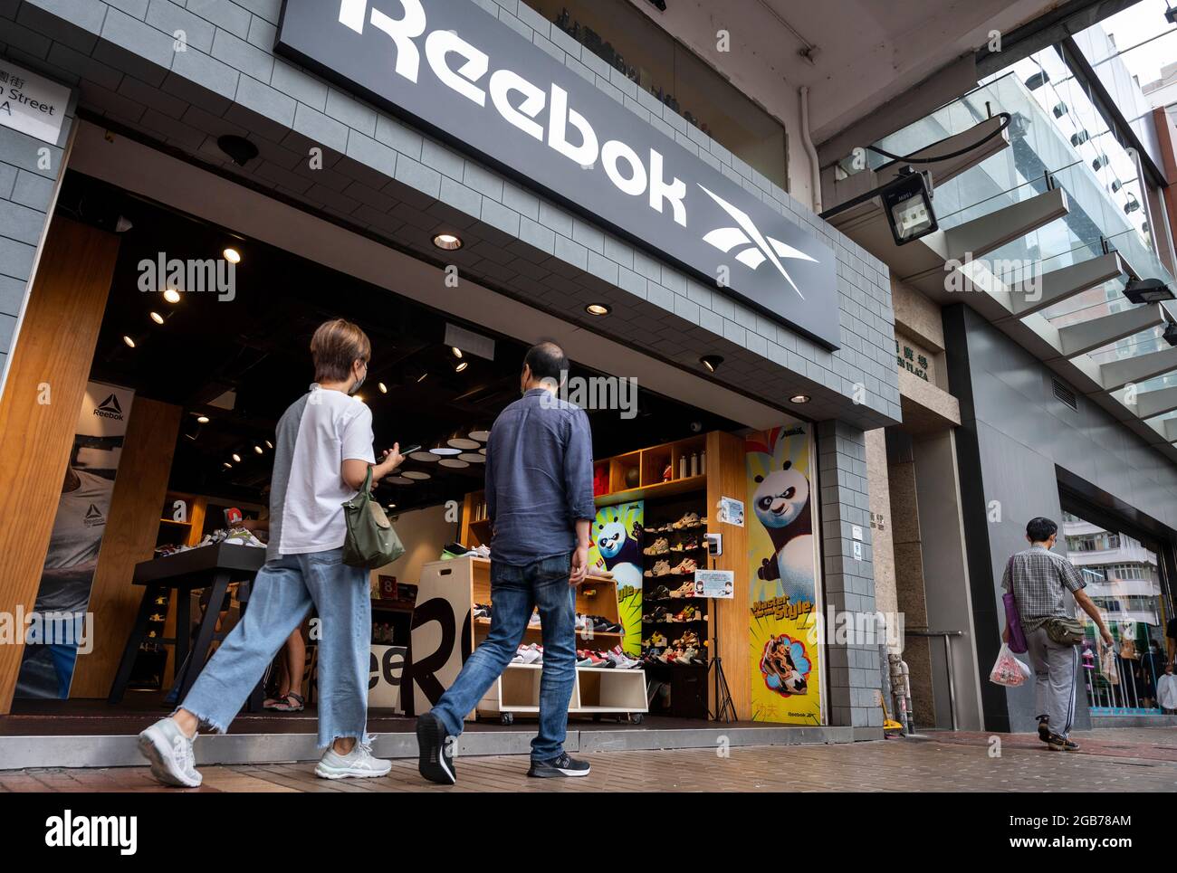 Pedestrians walk past the German multinational footwear company brand Reebok  store is seen in Hong Kong. (Photo by Budrul Chukrut / SOPA Images/Sipa USA  Stock Photo - Alamy