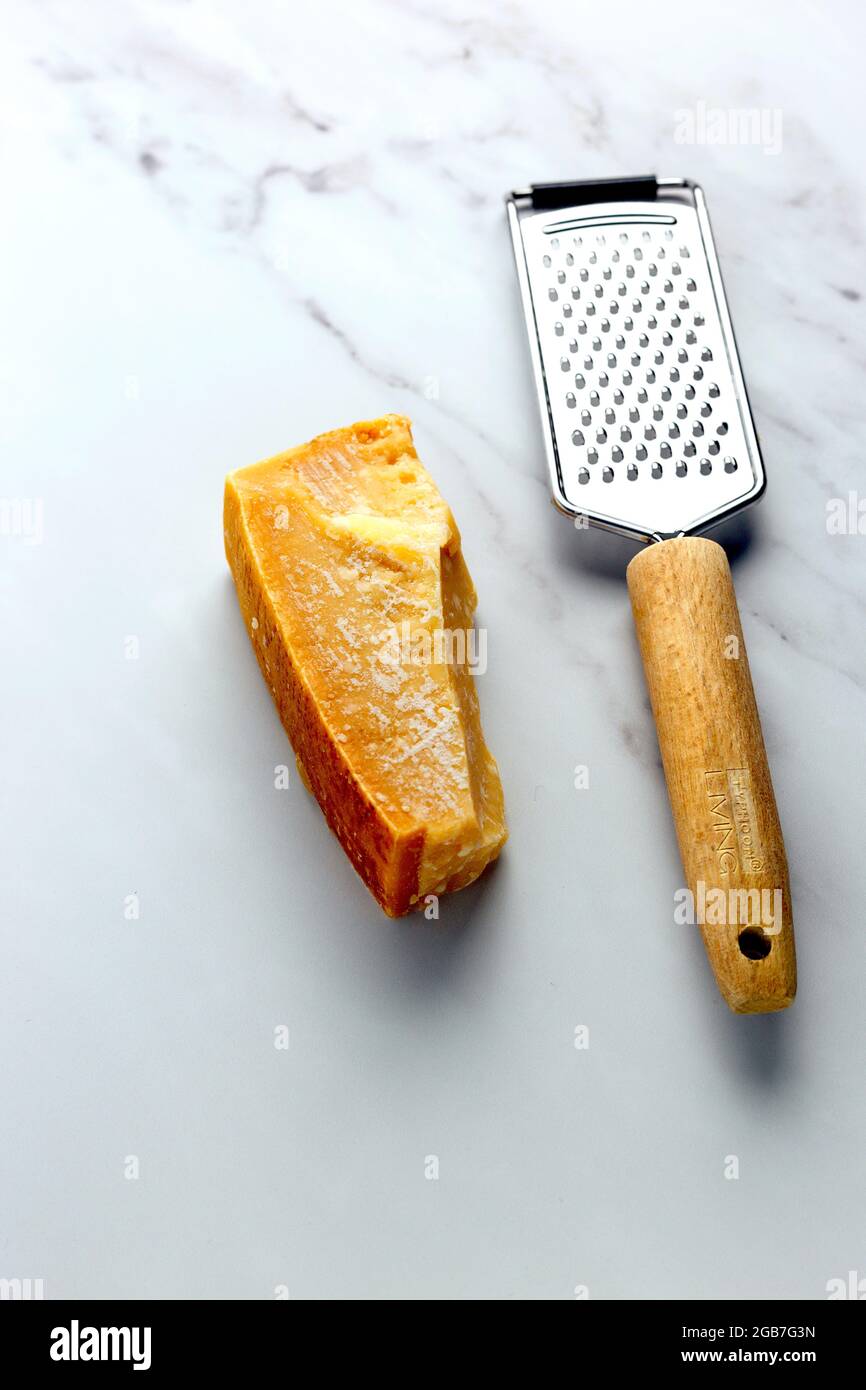 https://c8.alamy.com/comp/2GB7G3N/block-of-aged-parmesan-with-grater-foodpix-white-2GB7G3N.jpg