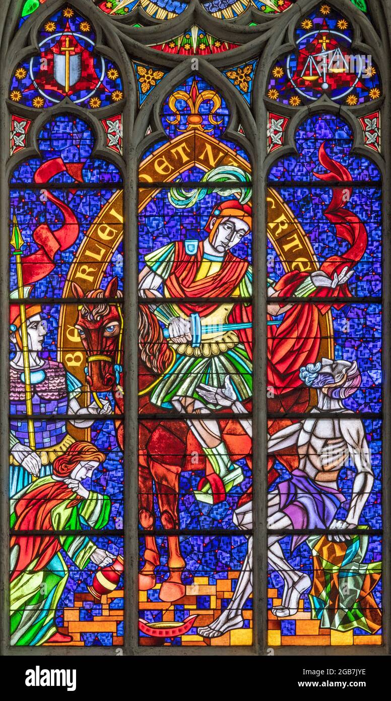 VIENNA, AUSTIRA - JUNI 24, 2021: The  St. Martin on the modern stained glass in the Votivkirche church from 20. cent. Stock Photo