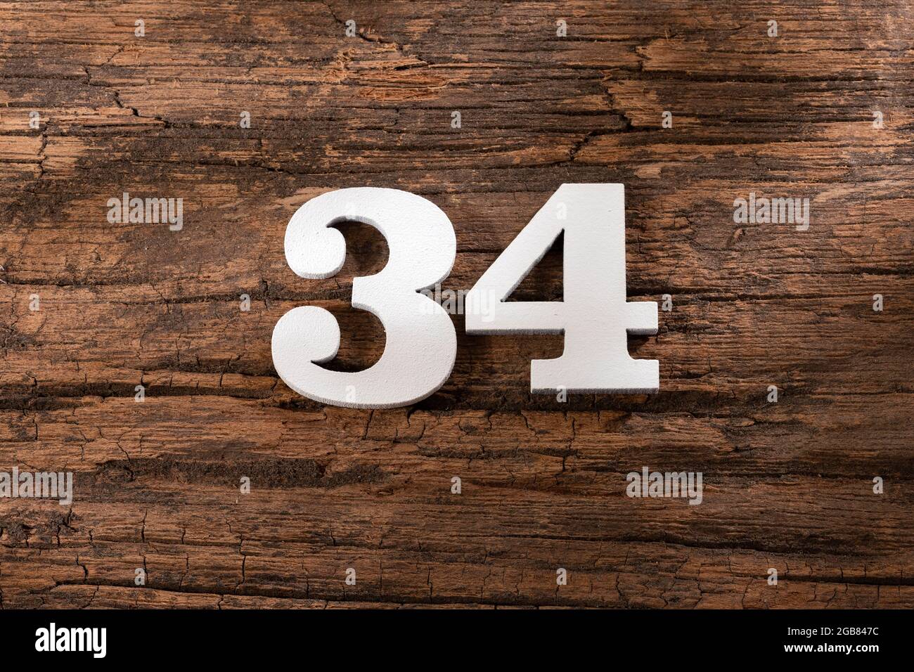 Number thirty four 34 - White Piece on Rustic Wood Background Stock ...