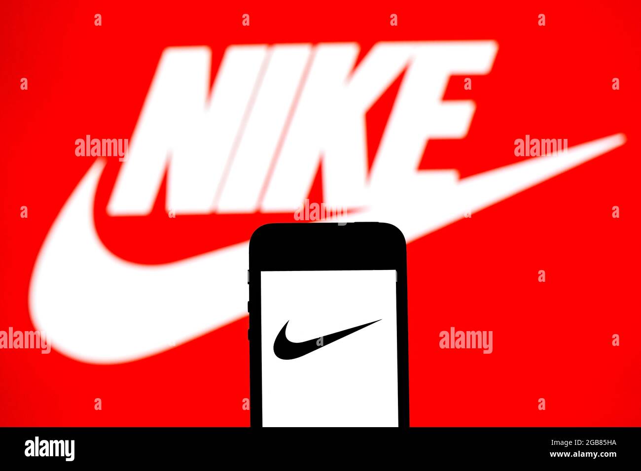 Barcelona, Catalonia, Spain. 31st July, 2021. In this photo illustration a  Nike, Inc. logo seen displayed on a smartphone with a Nike, Inc. logo in  the background. (Credit Image: © Thiago Prudencio/DAX