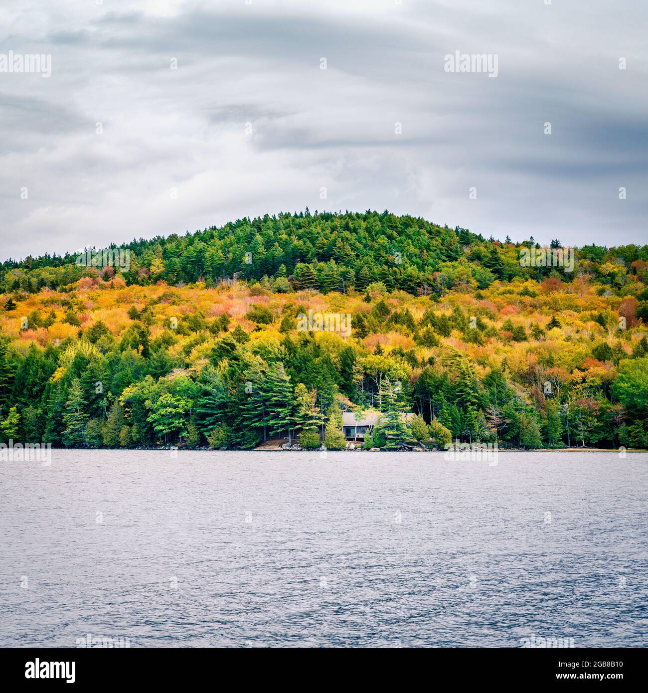 Fall colors on the shores of Long Pond in Acadia National Park in Maine Stock Photo