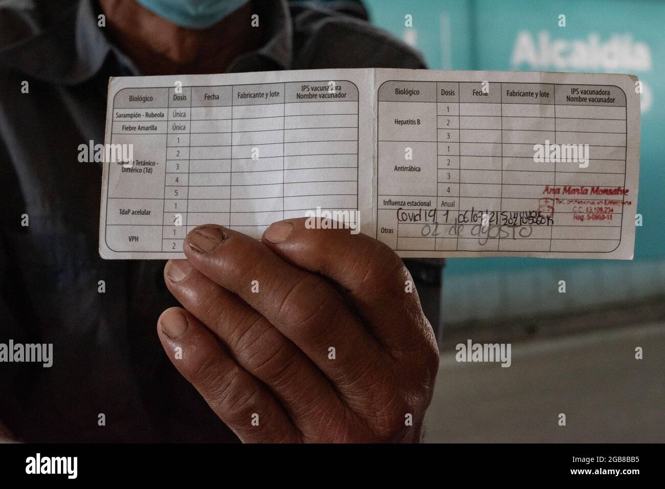 Bogota, Colombia. 2nd Aug 2021. A person vaccinated holds the 'Mi Vacuna' vaccination documentation given to Colombian citizens as people from ages 25 to 30 start their vaccination phase with the Moderna novel COVID-19 vaccine against the Coronavirus disease in Medellin - Antioquia, Colombia on August 2, 2021. Credit: Long Visual Press/Alamy Live News Stock Photo