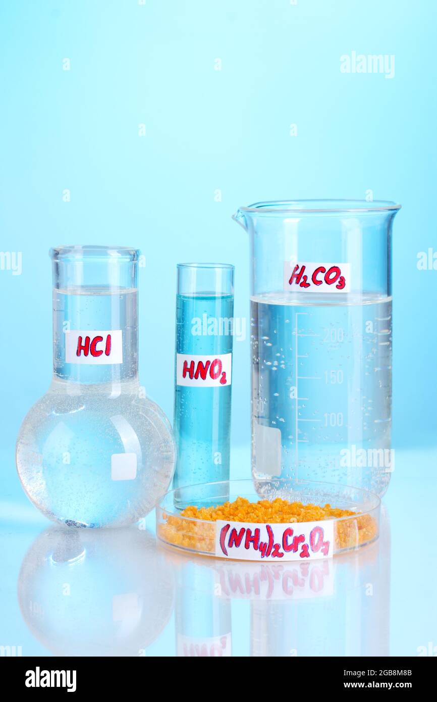 Test-tubes with various acids and chemicals on blue background Stock ...