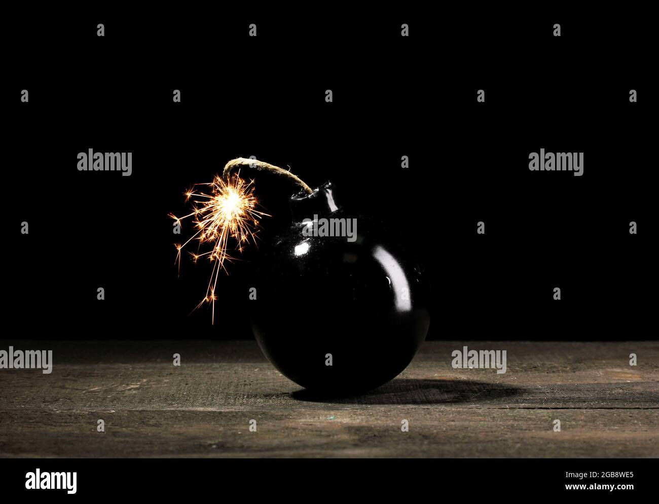 Setting Bomb Background Cartoon style bomb on wooden table on black background Stock Photo - Alamy