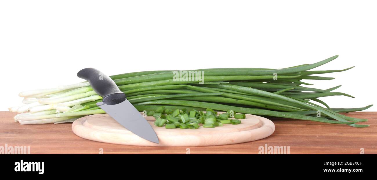 Green onion on a cutting board with knife on wooden Stock Photo - Alamy