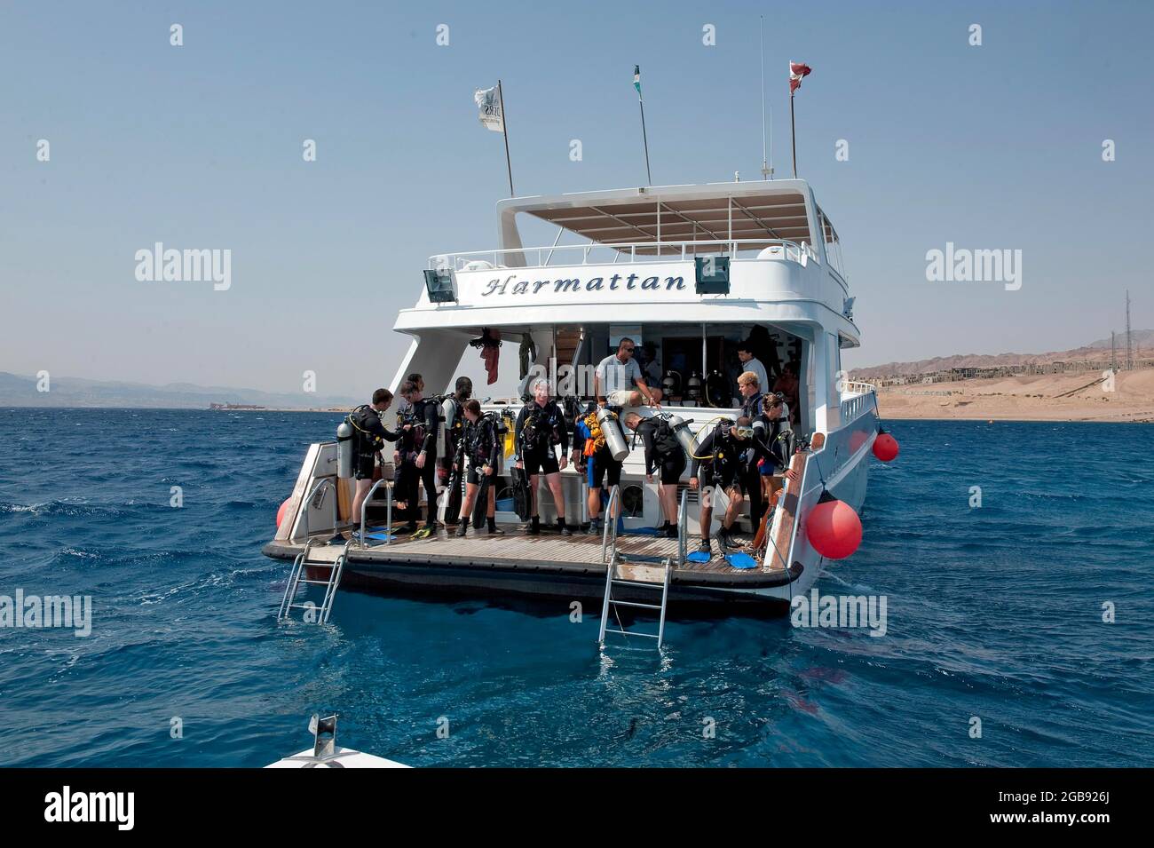 Divers standing on diving platform of dive boat, Red Sea, Aqaba, Jordan Stock Photo