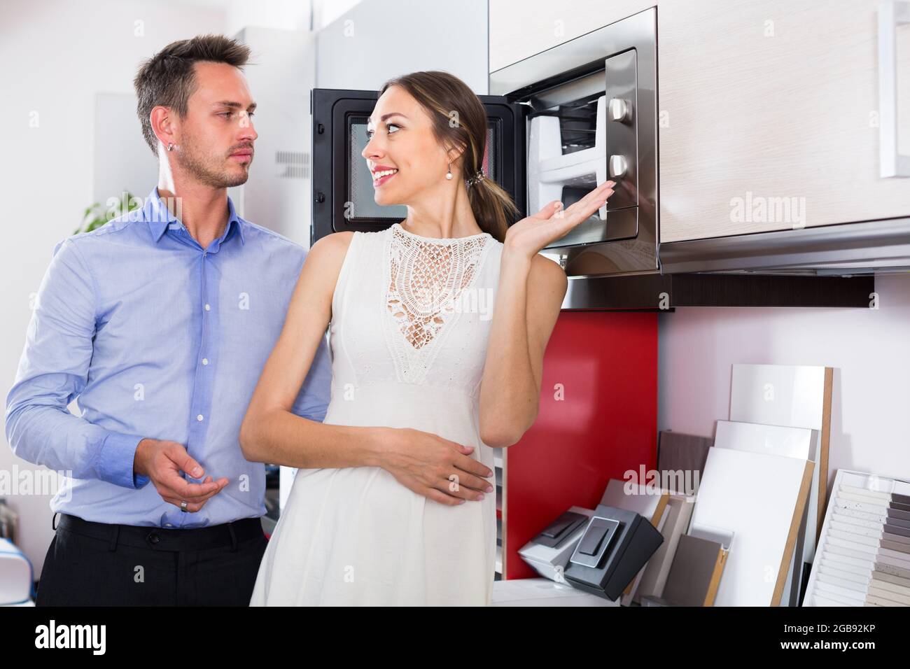 Adutl couple is choosing new microwave Stock Photo