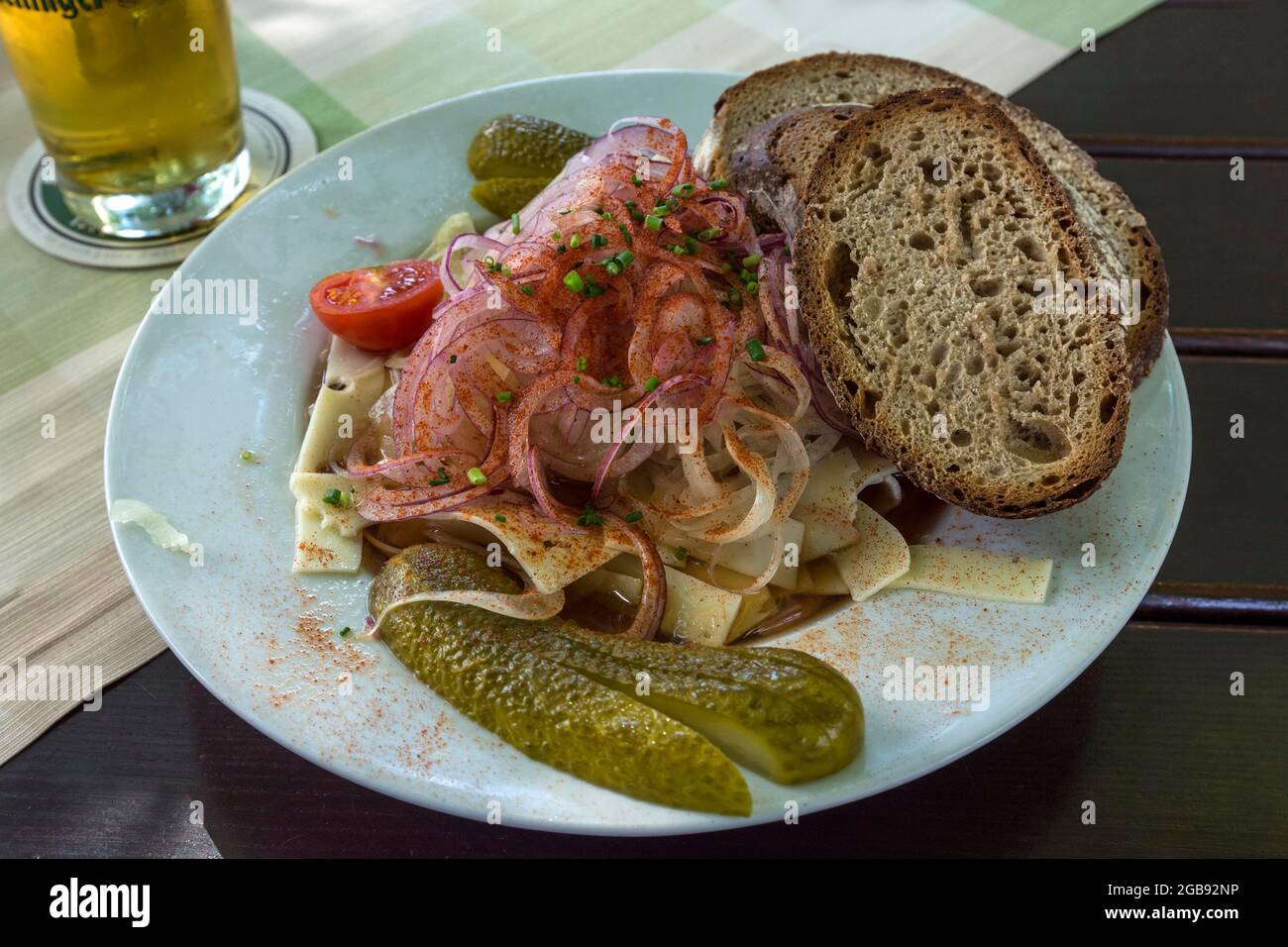 Swiss sausage salad with bread on a plate in a garden restaurant, Regensburg, Upper Palatinate, Bavaria, Germany Stock Photo