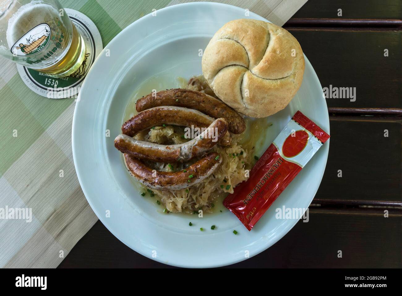 Bratwurst with sauerkraut and bread rolls on a plate in a garden restaurant, Regensburg, Upper Palatinate, Bavaria, Germany Stock Photo