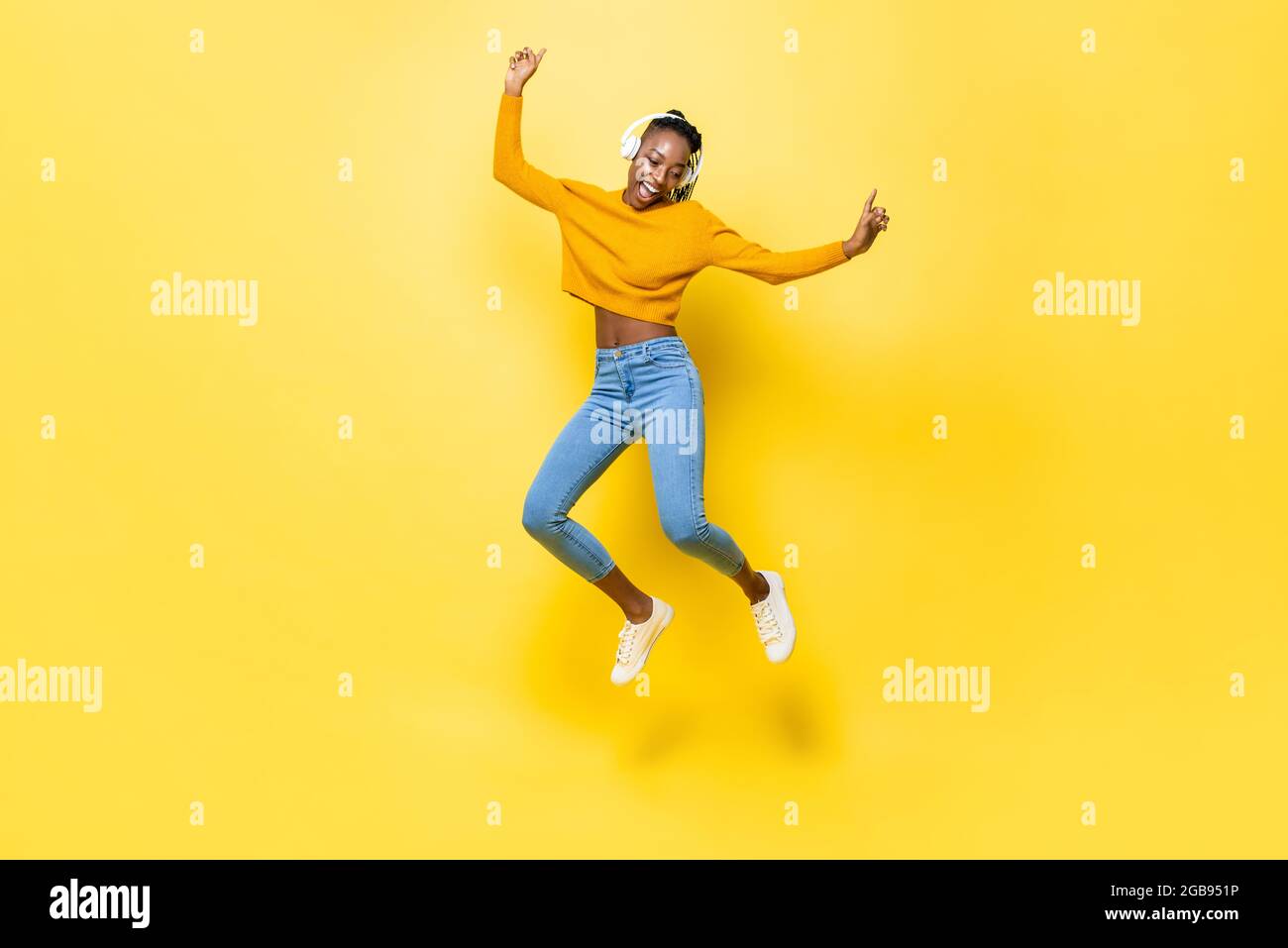 Jumping portrait of happy energetic young African American woman ...