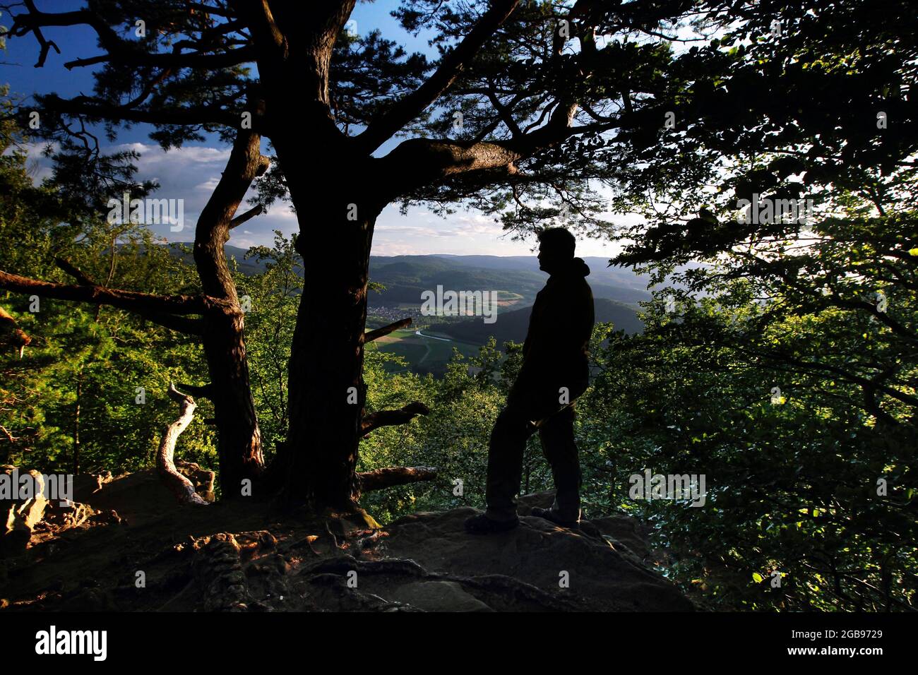 Man looking from the Teufelskanzel at Werraschleife and Werra-Bergland, hiker, silhouette, Gruenes Band, border path, inner German border Stock Photo