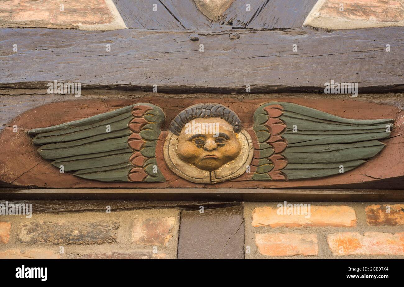 Carved angel figure on the front of the old famous half-timbered house ...