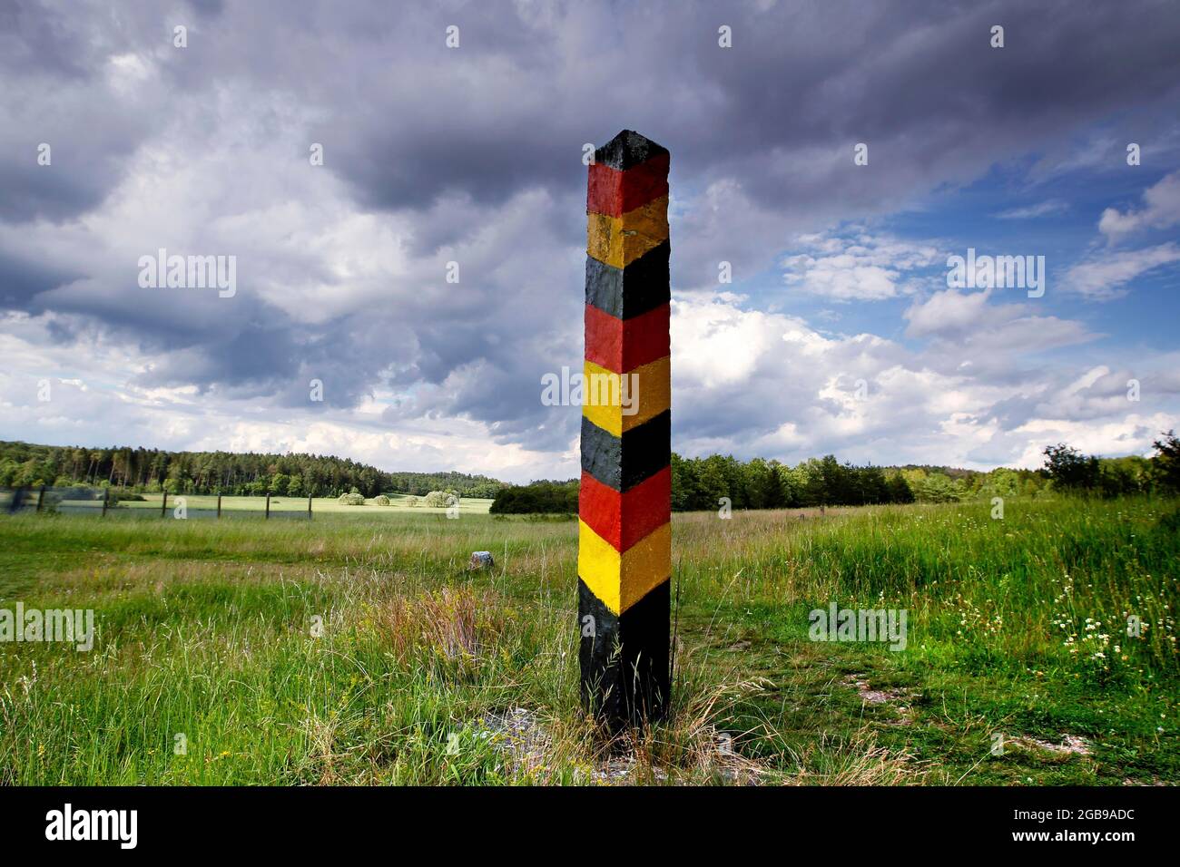 GDR border post, border post, column trail, hiking trail through meadows and woodland, perforated flagstone trail, inner-German border installation Stock Photo