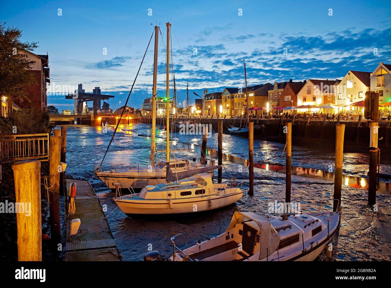 Husum harbour, tidal harbour at low tide in the evening, inland harbour, city harbour, Husum, North Frisia, Schleswig-Holstein, Germany Stock Photo
