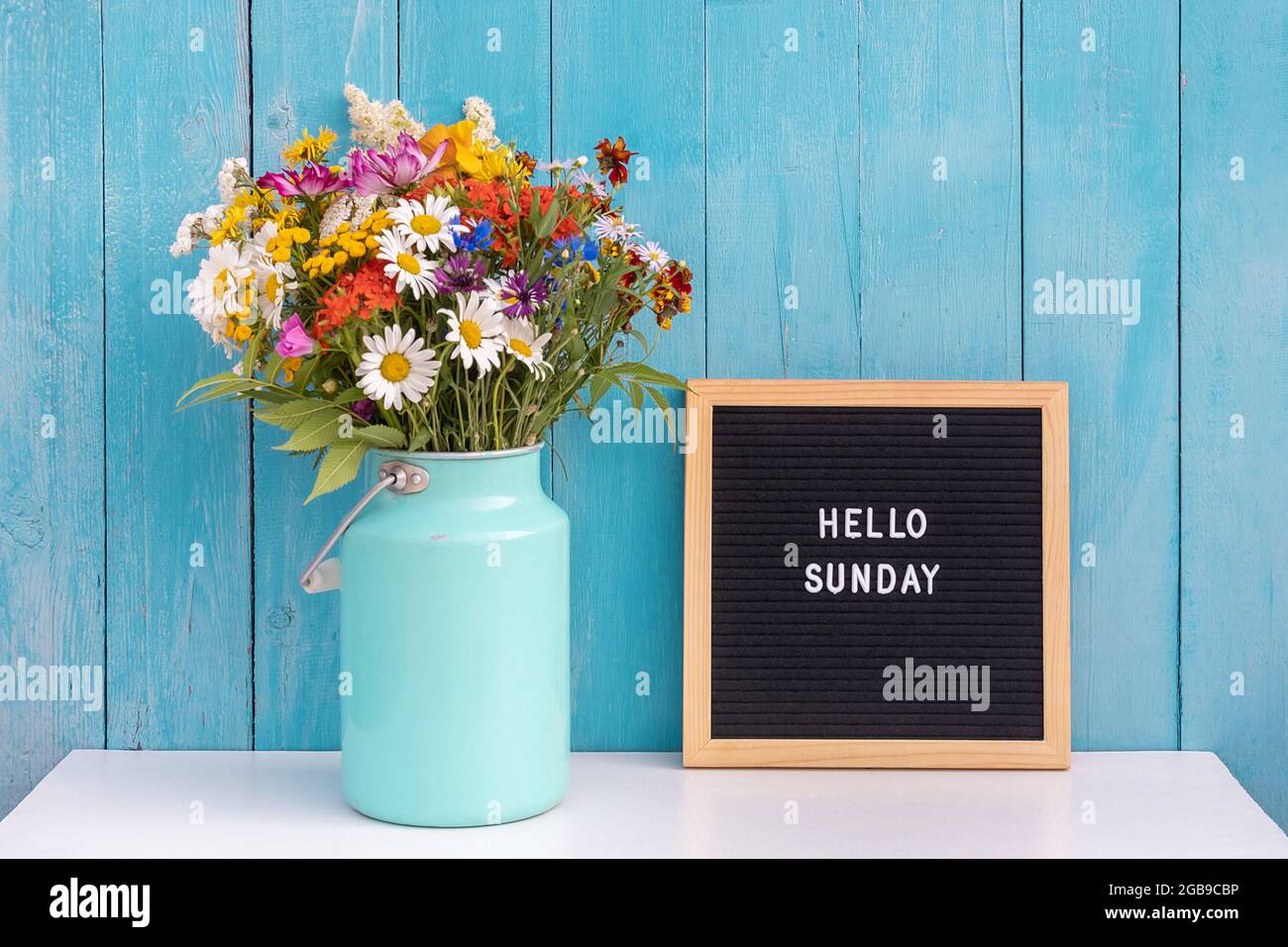 Happy Sunday words on black letter board and bouquet of bright ...