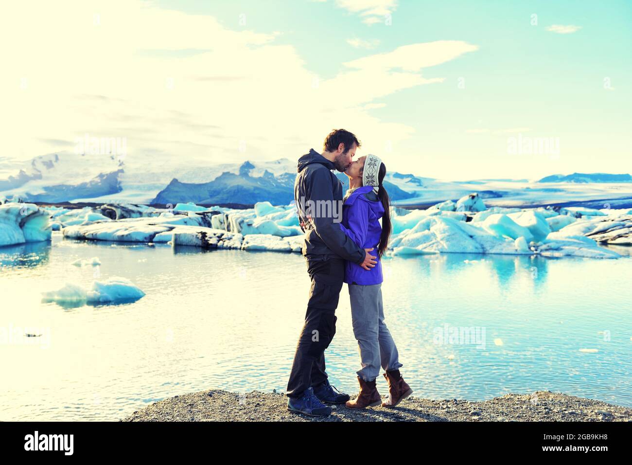 Kissing romantic couple in love on Iceland. by Jokulsarlon glacial lagoon, Iceland. Stock Photo