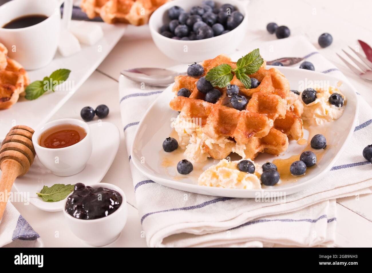 Waffles with blueberries and whipped cream Stock Photo - Alamy