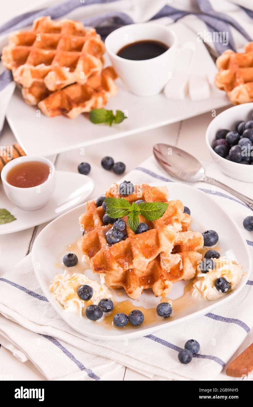 Waffles with blueberries and whipped cream Stock Photo - Alamy