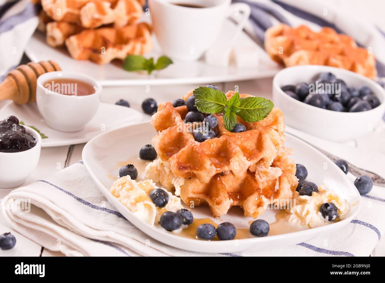 Waffles with blueberries and whipped cream Stock Photo - Alamy