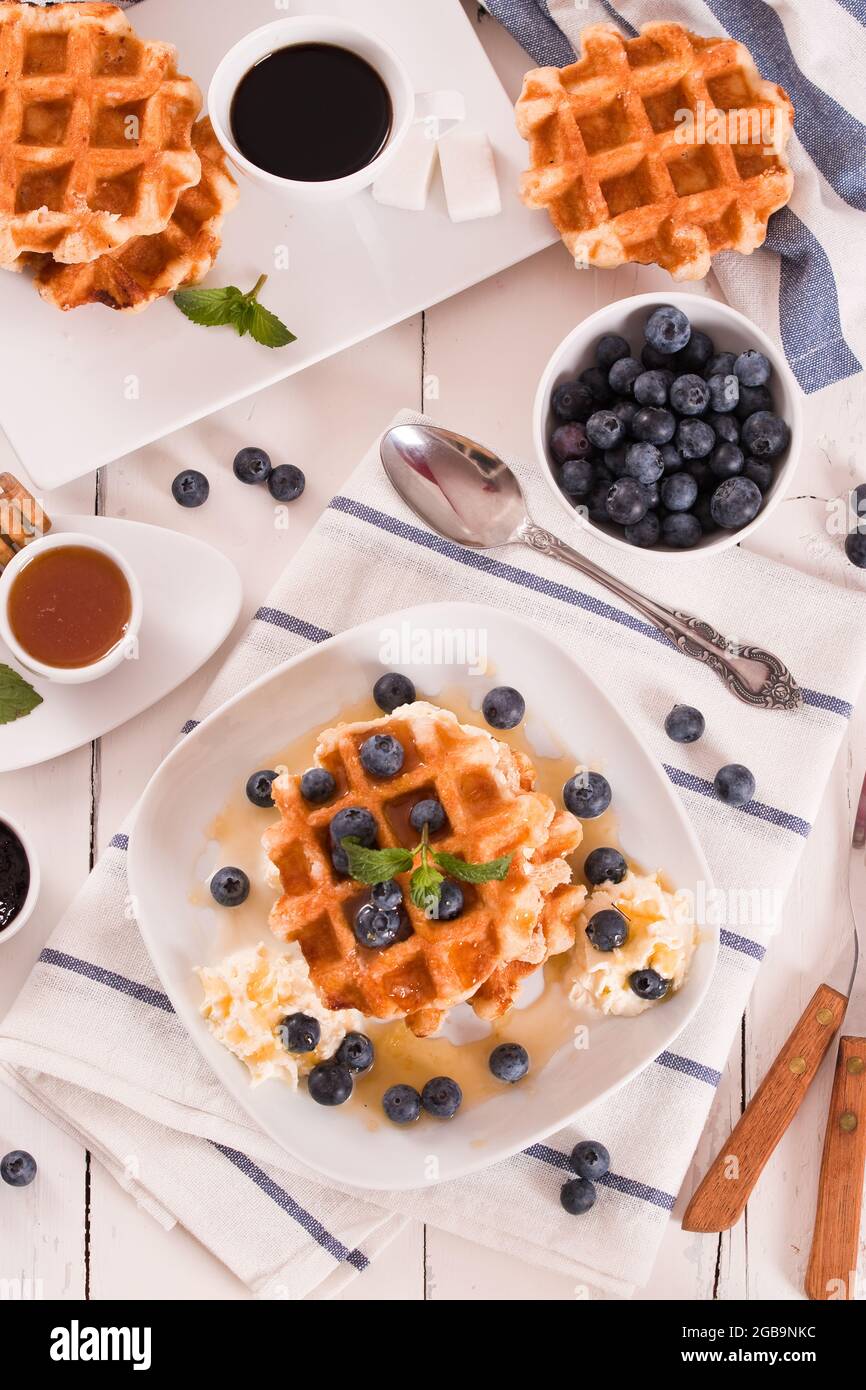 Waffles with blueberries and whipped cream Stock Photo - Alamy