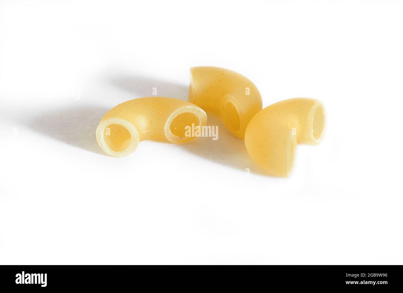 Three macaroni isolated on a white background. Macro.  Stock Photo
