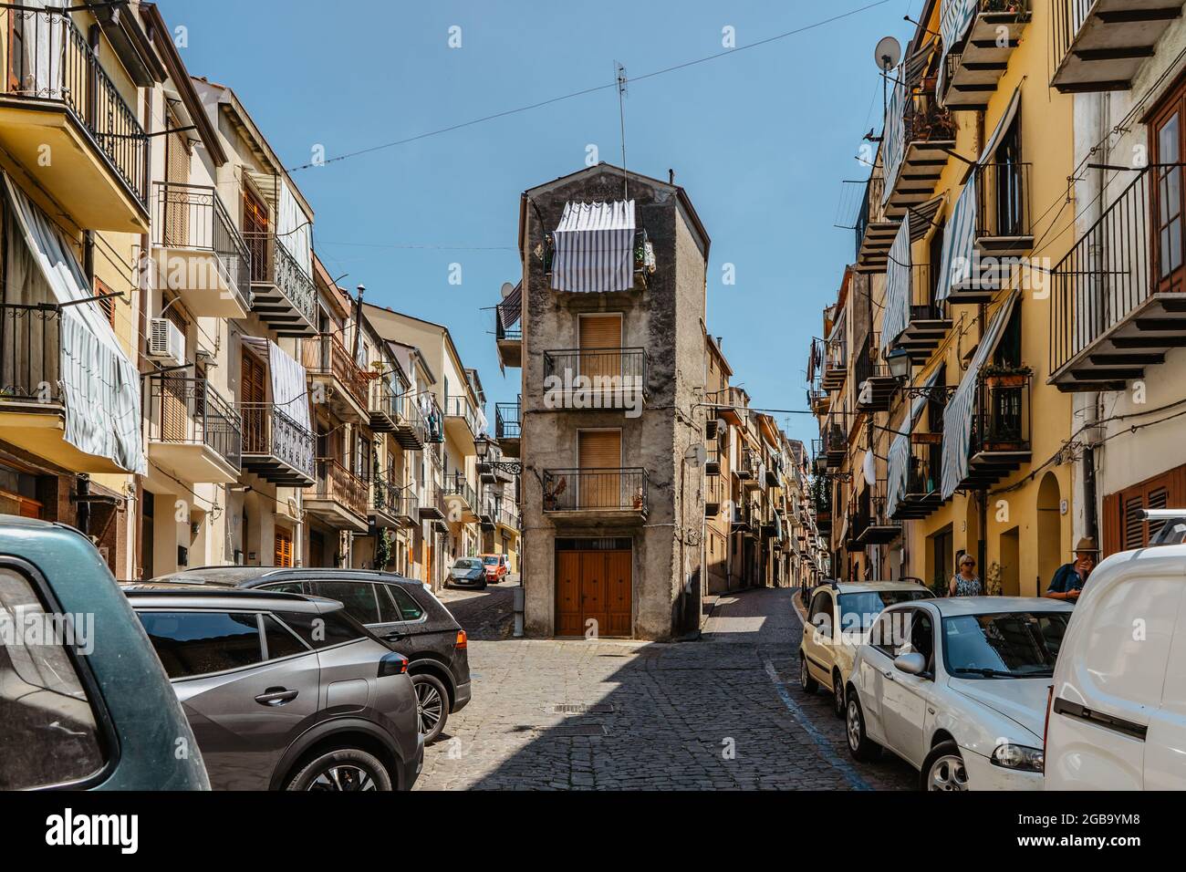 Castelbuono, Sicily - June 6, 2021. Tourists walking through narrow streets of small medieval village in the Park of Madonie.It is known for panettone Stock Photo