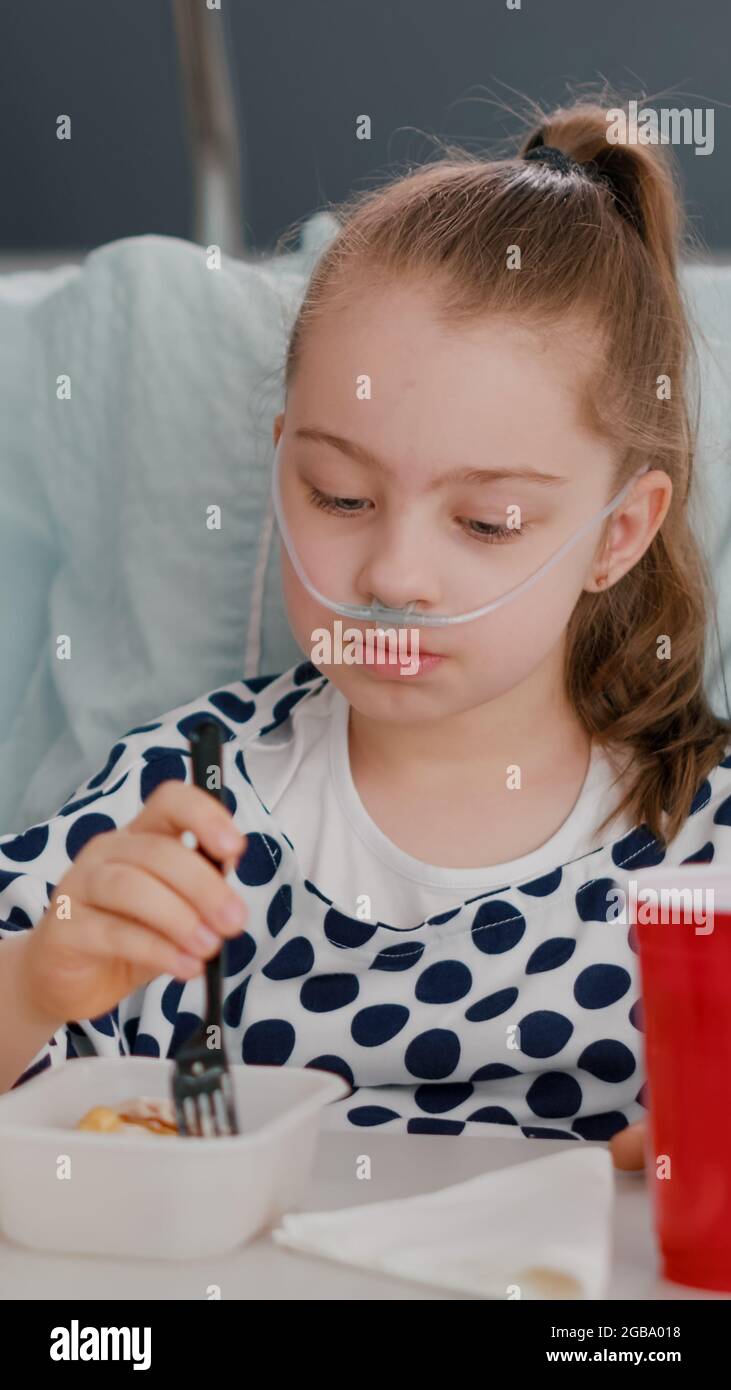 Hospitalized sick daughter recovering after medical surgery eating