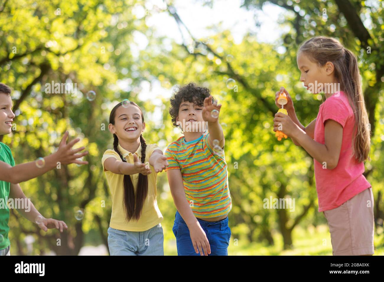 Children playing with soap bubbles in nature Stock Photo - Alamy