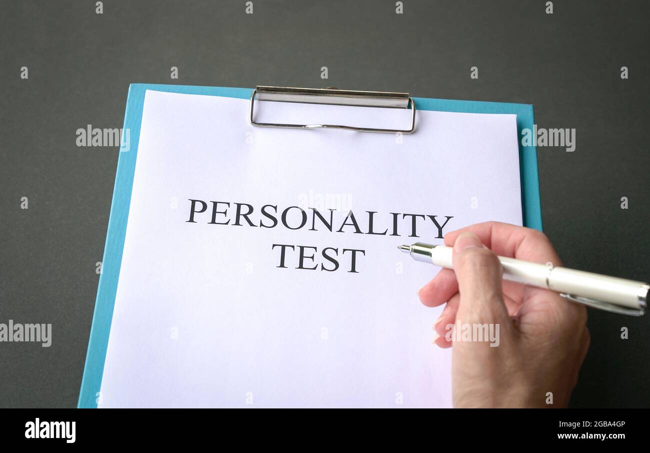 Job applicant to do personality test. On dark grey tabletop. Stock Photo