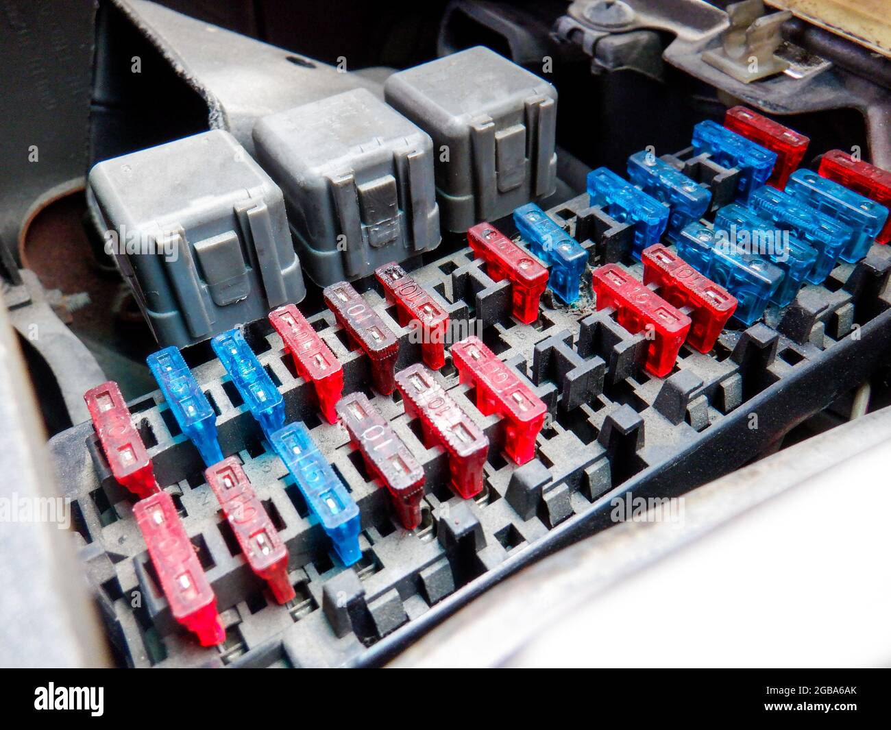 Colorful car fuse box and multiple protection fuses. Stock Photo