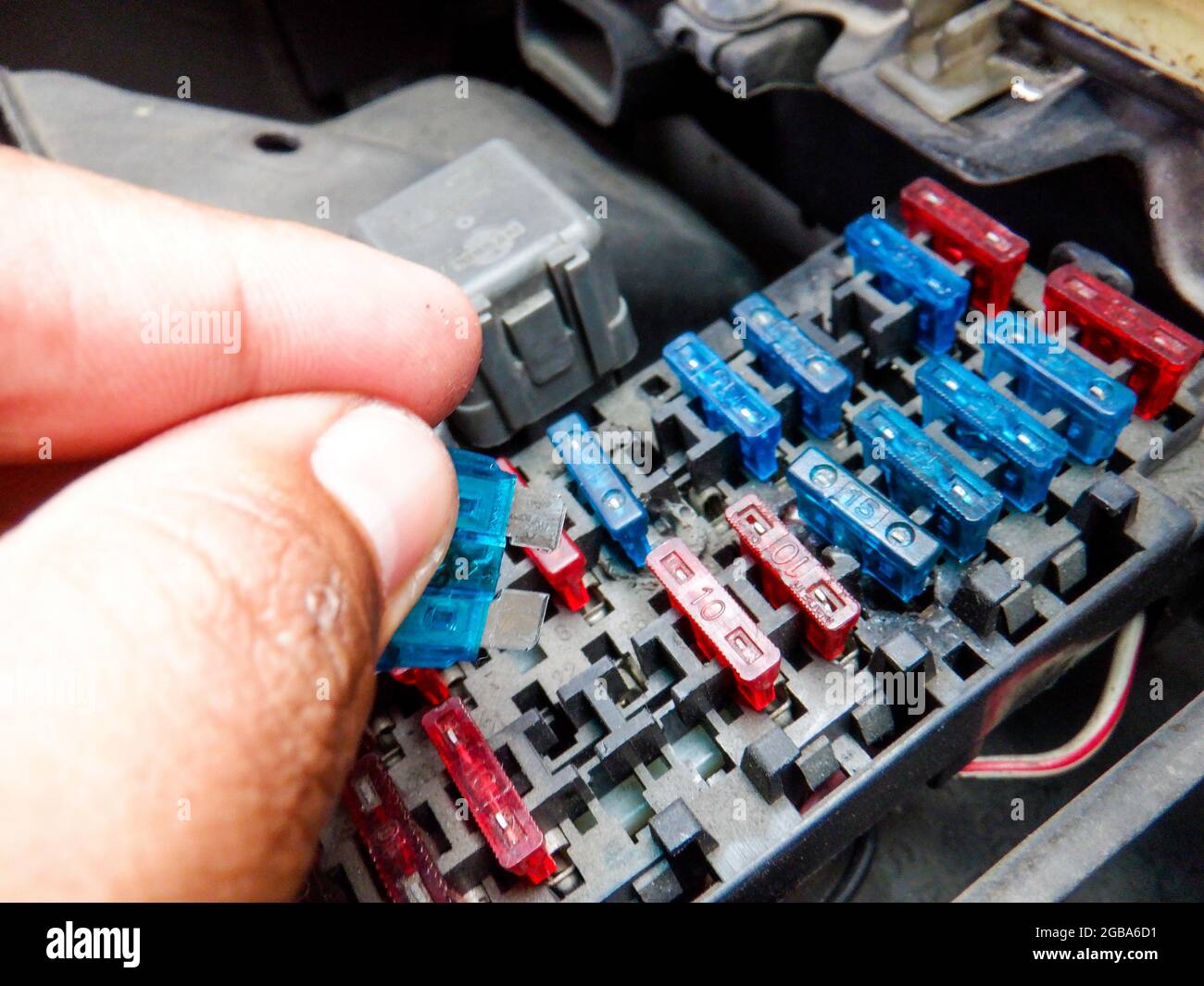Colorful car fuse box and multiple protection fuses. Stock Photo