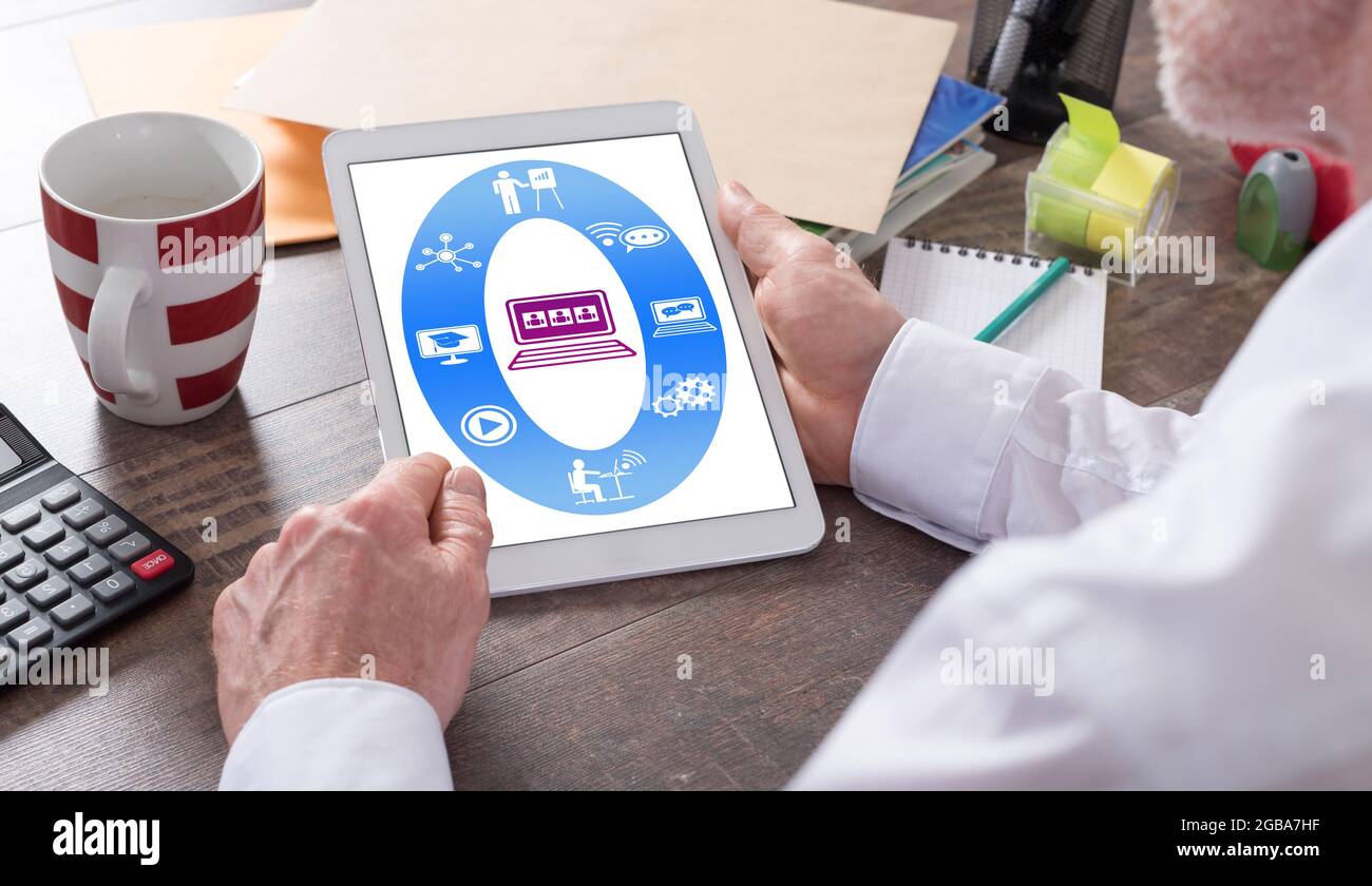 Webinar concept shown on a tablet held by a man Stock Photo