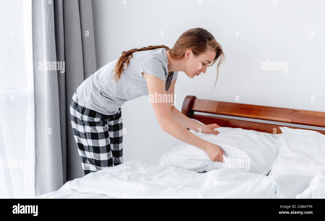 Girl making the bed Stock Photo Alamy
