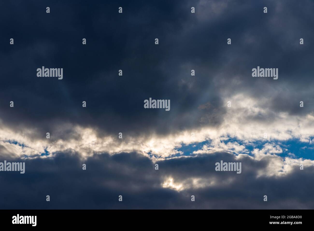 Rays of light shining throug dark clouds.Beautiful dramatic sky with sun rays.dramatic sky sun rays. Stock Photo