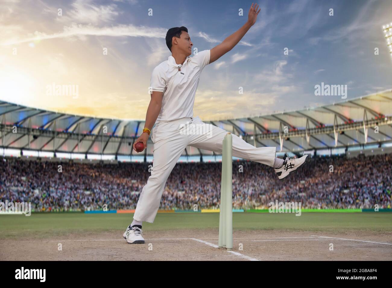 Cricketer, Bowler bowling during a match Stock Photo
