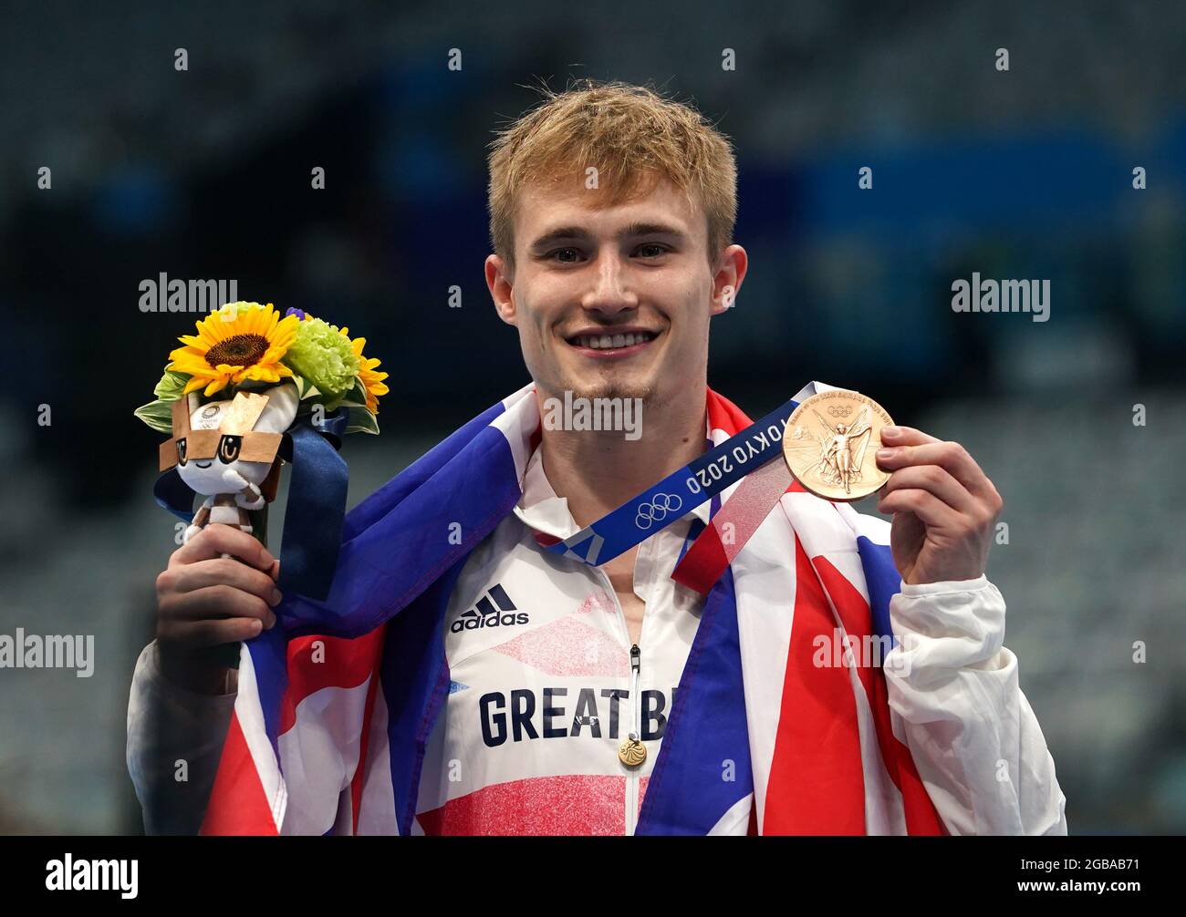 Great Britain's Jack Laugher celebrates on the podium with the bronze ...