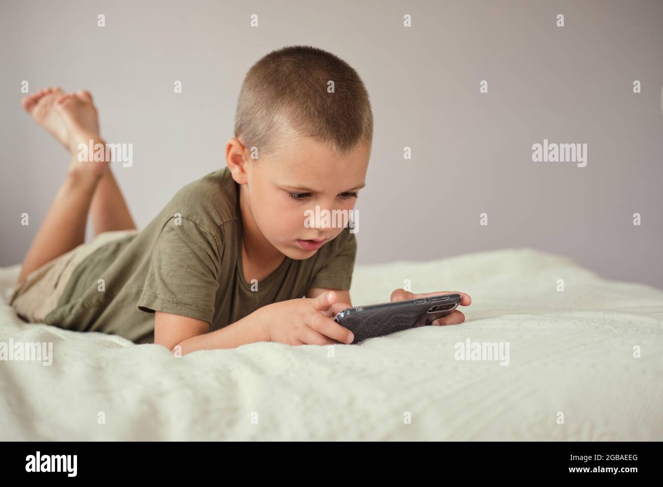 Very happy child playing game online with laptop stay at home. Asian boy  student online learning class study online video call teacher Stock Photo -  Alamy